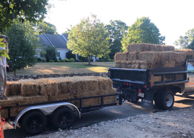 Bales of hay on back of delivery truck