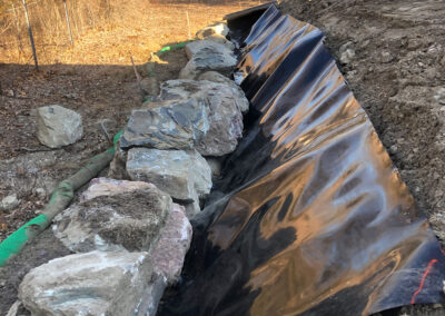 large rocks lined up next to hill